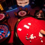 KJC gaming table scene with vibrant action, poker chips, and a roulette wheel highlighting luxury and excitement.
